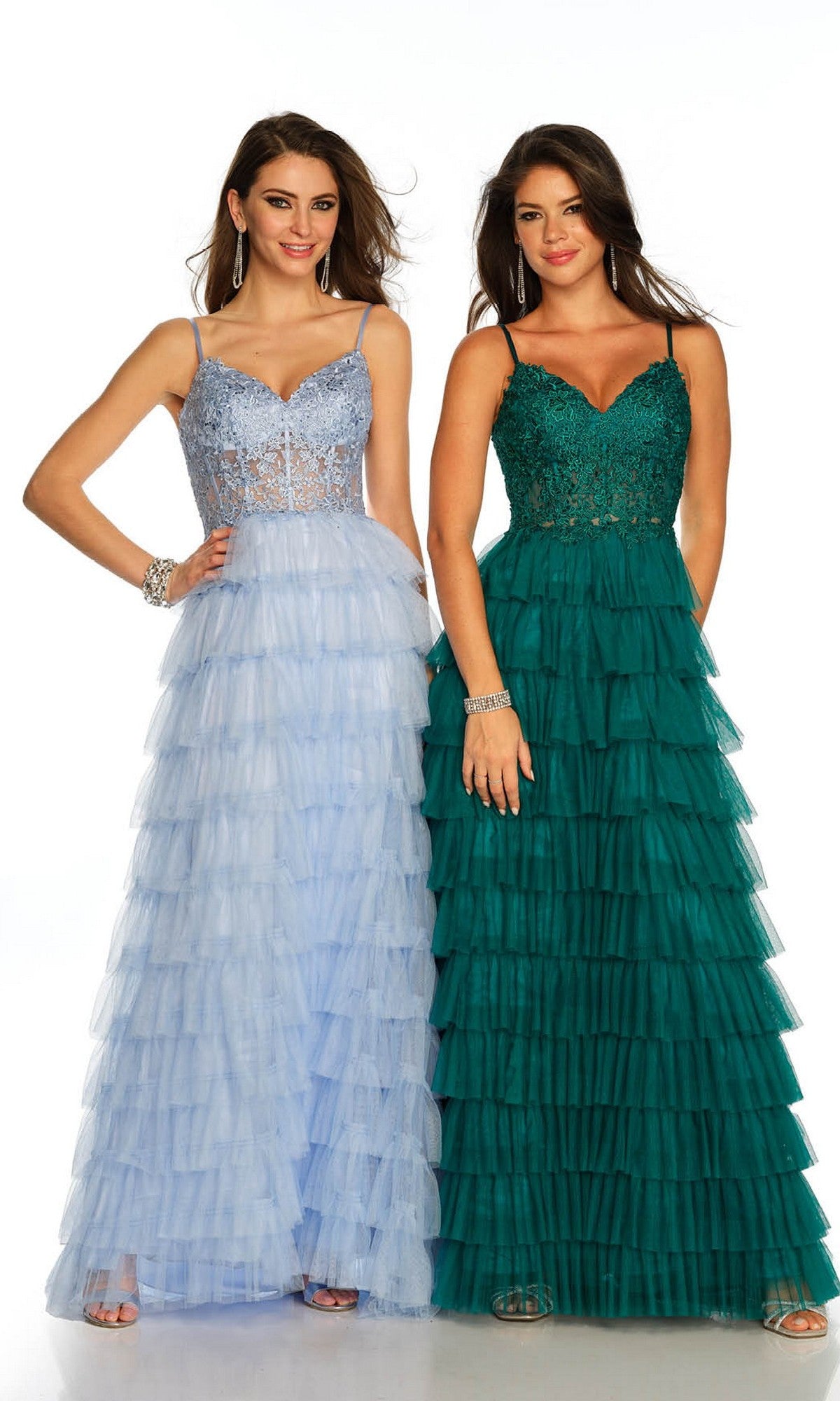 Two women stand side by side wearing Dave and Johnny Long Tiered Prom Dress 11148—one in light blue with lace details and a v-neckline, the other in emerald green with a coordinating bodice.